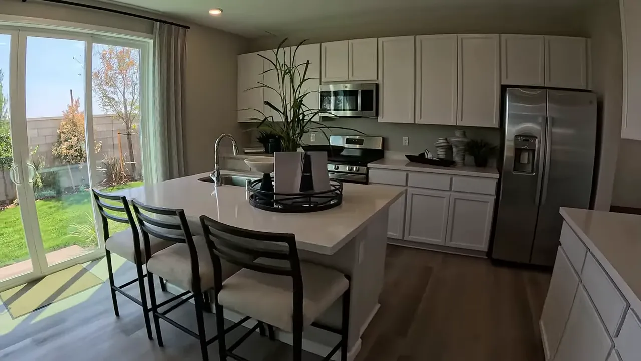 Open concept kitchen with island and stainless steel appliances