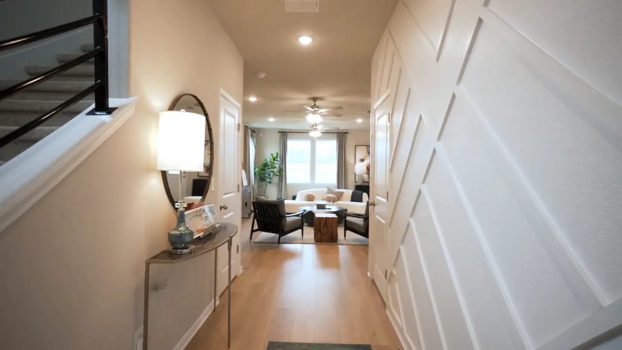 Hallway view in a new affordable construction home with tile flooring and recessed lights
