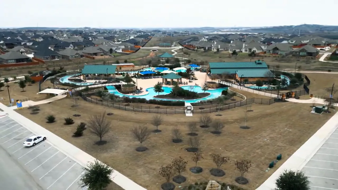 Aerial view of Sunfield community pool and amenity area in Buda TX