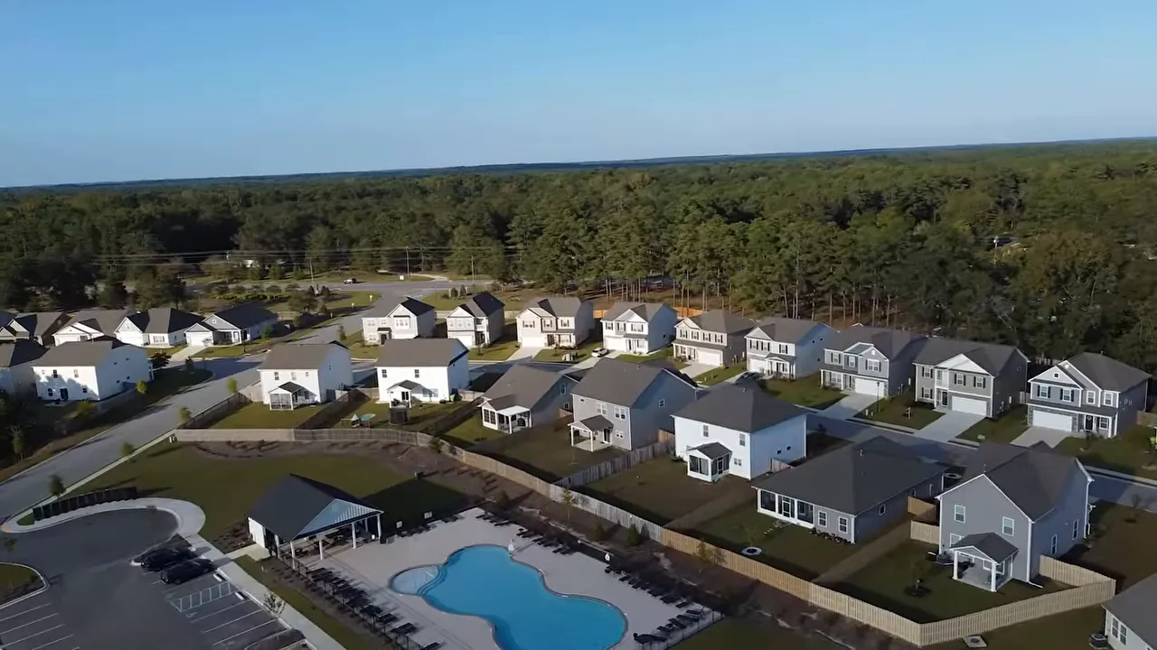 Aerial view of a large new construction neighborhood with a community pool