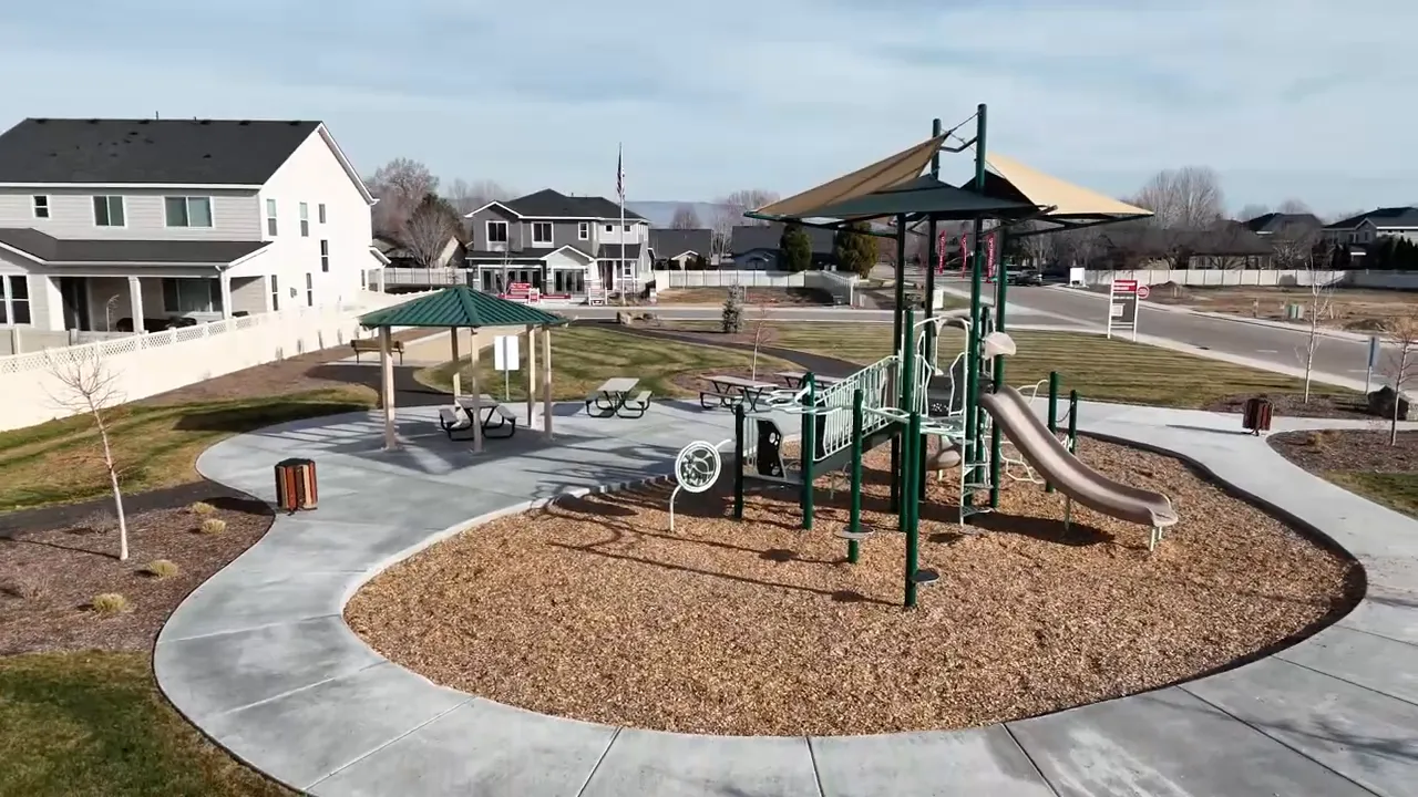 Clear aerial-style view of playground, walking paths, and nearby houses in the community