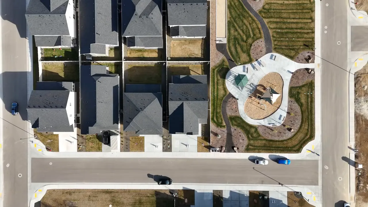 Top-down aerial image of houses and an adjacent playground in the Friendship Subdivision