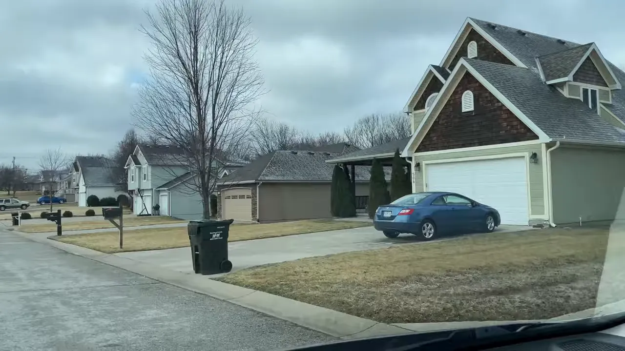 Clear drive-by photo of Fountain Crest homes with garages, mailboxes and modest front yards