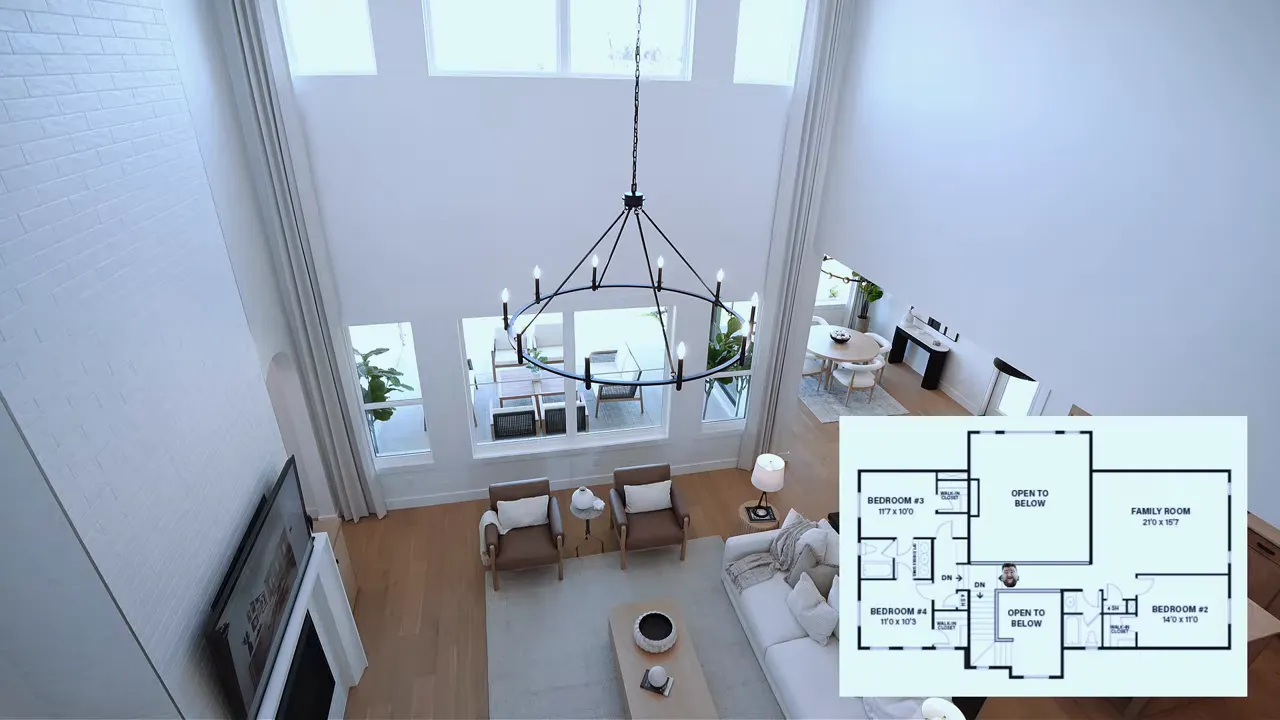 Clear overhead view of two-story living room with chandelier, windows and floorplan inset