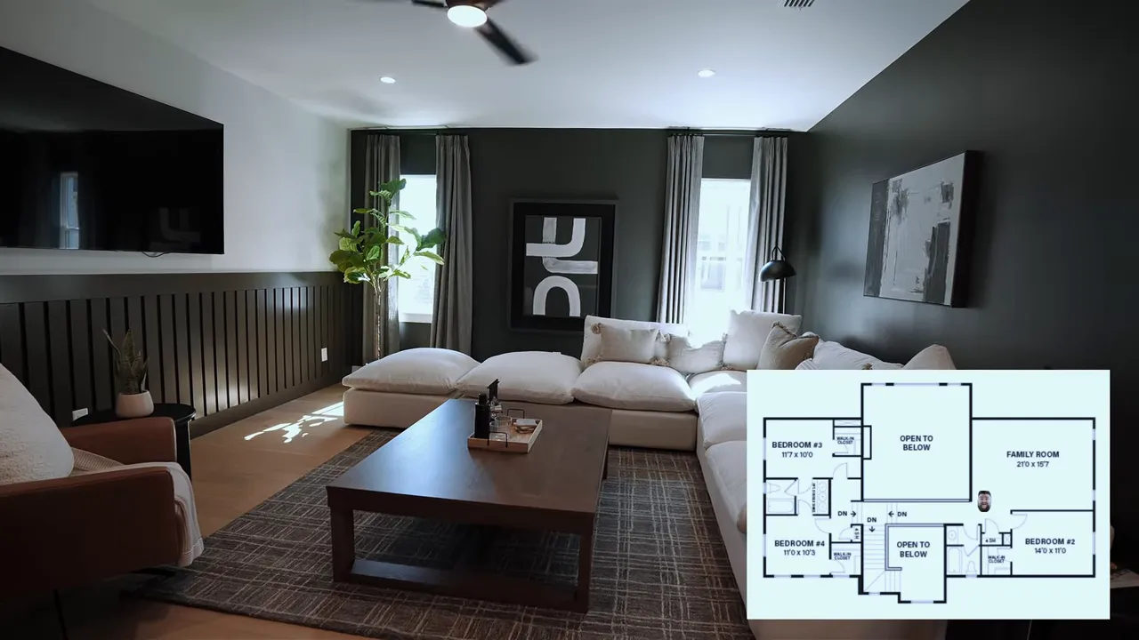 Spacious family room with dark accent wall, sectional seating and a small floorplan inset in the corner