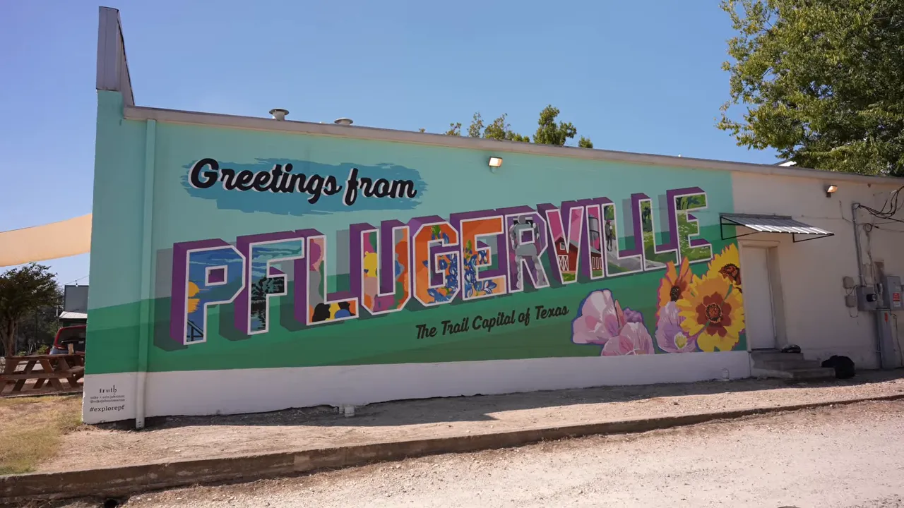 Colorful mural reading greetings from Pflugerville