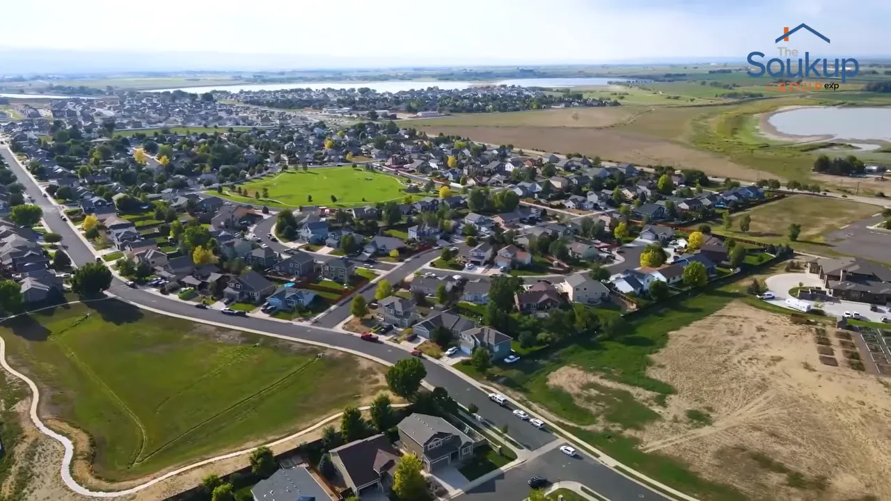 Aerial view of homes beside green open space and walking paths