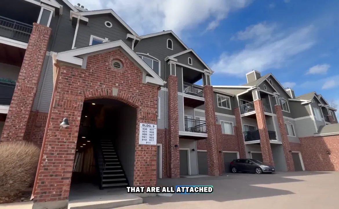 Attached condo community with brick entry and balconies