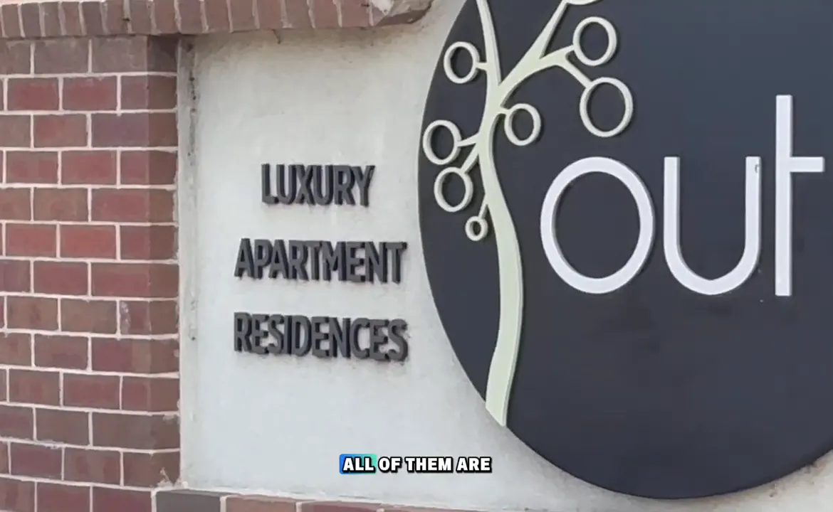 Luxury apartment residences sign on brick entrance wall