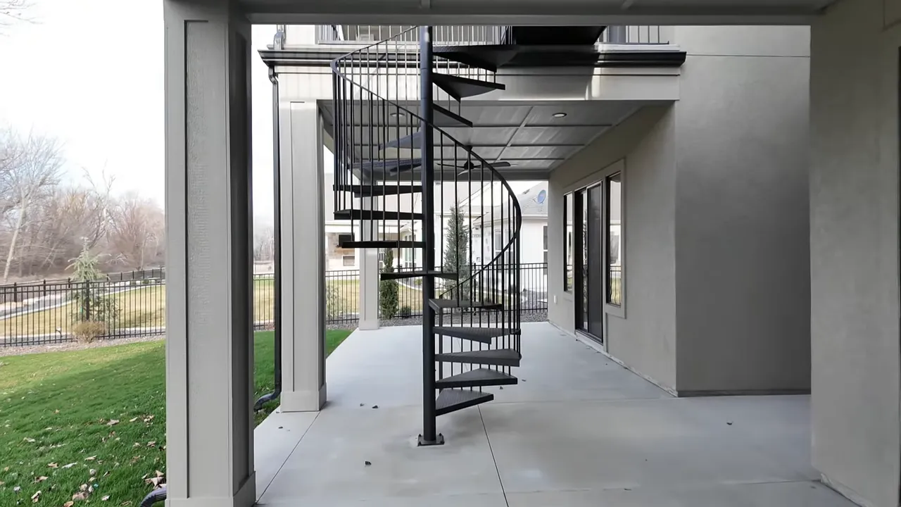 Open covered patio hallway with spiral staircase in a Middleton, Idaho Boise River home