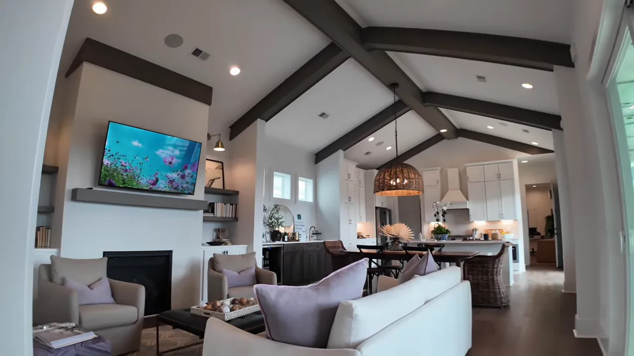 Open living room and kitchen with vaulted ceiling in the Anetto model home at Midtown Nexton in Summerville SC