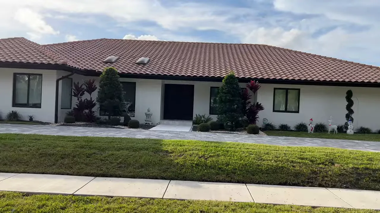 front-facing Mediterranean-style single-story home with tile roof, stucco exterior and landscaped entry