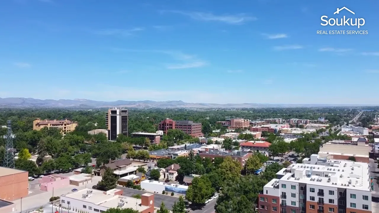 Wide aerial shot of Fort Collins urban area and surrounding mountains