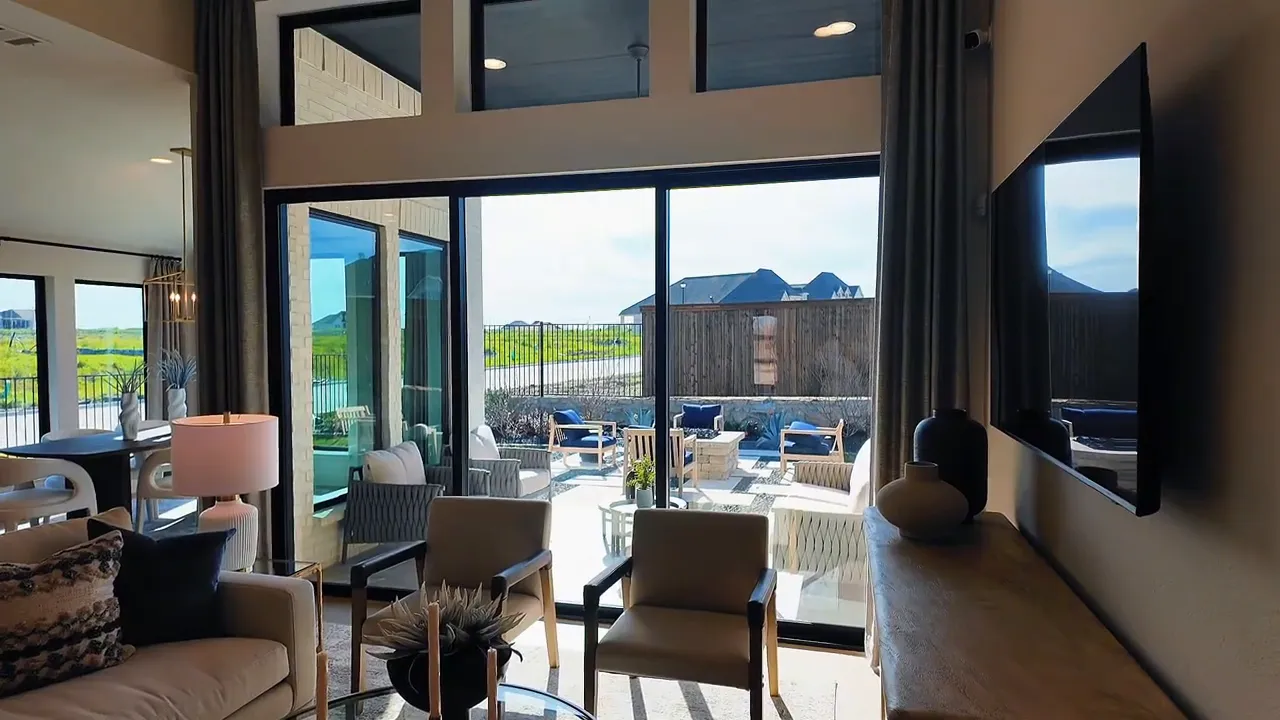 Living room opening to covered patio through large sliding glass doors with outdoor seating