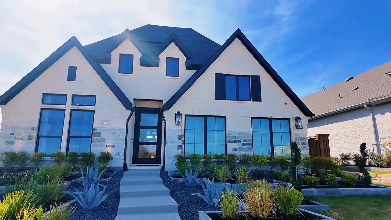 Modern neutral exterior of a new construction home near Dallas at Meraki by Perry Homes in Forney