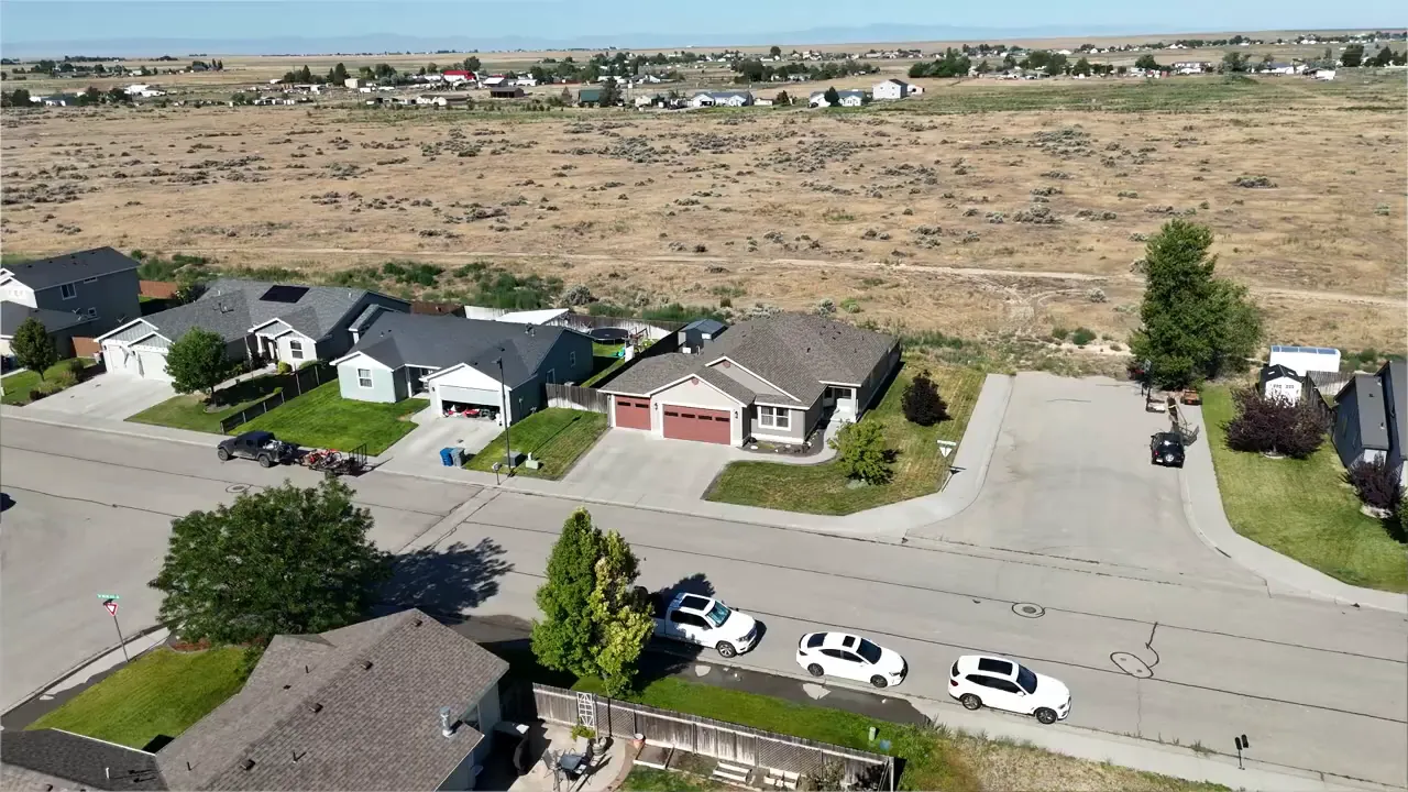Aerial view of suburban homes and streets with open land around Mountain Home Idaho