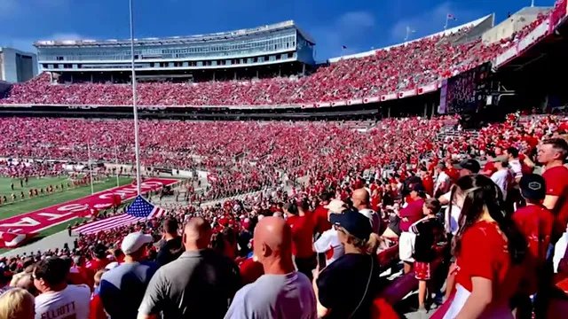 Crowded football stadium filled with fans in red