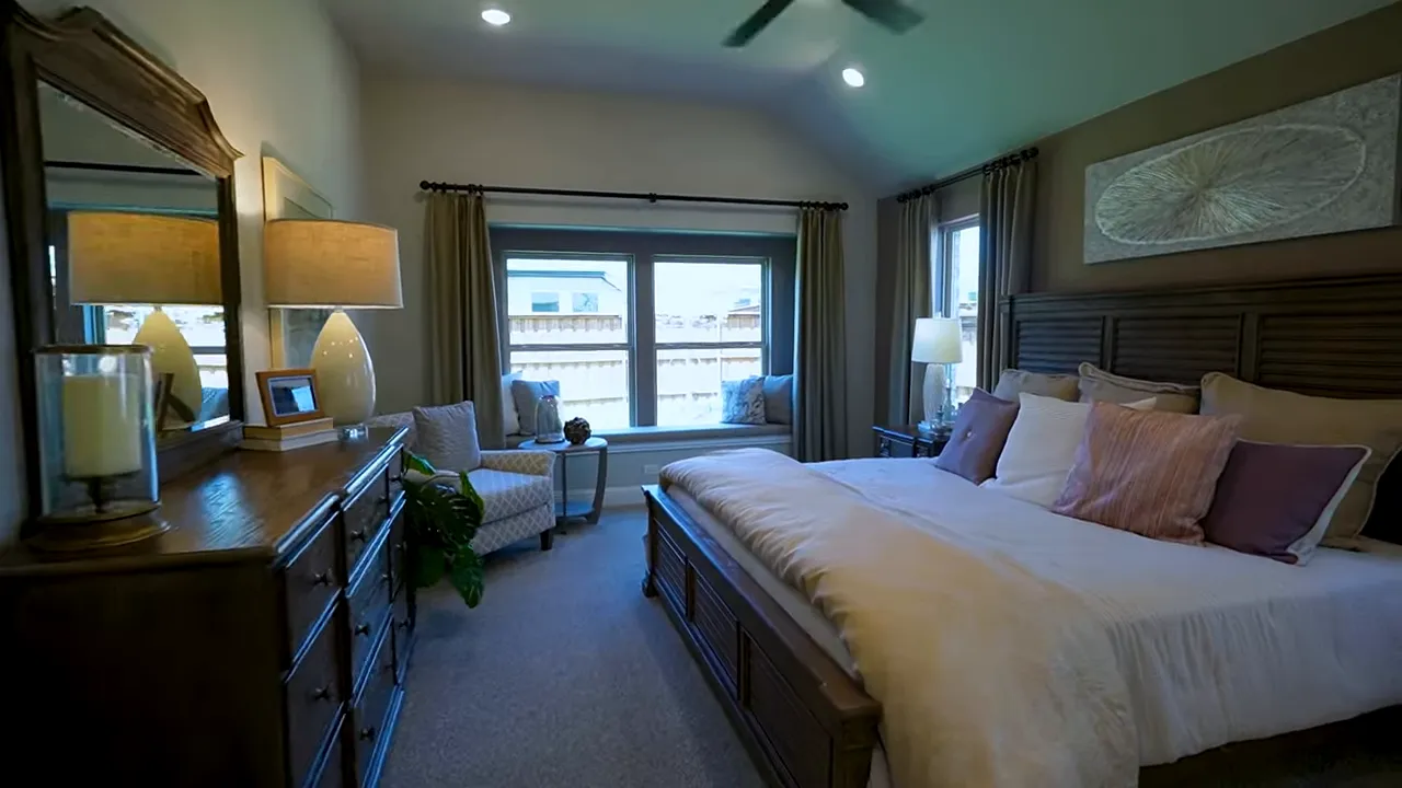 Primary bedroom with raised ceilings and window bench seat