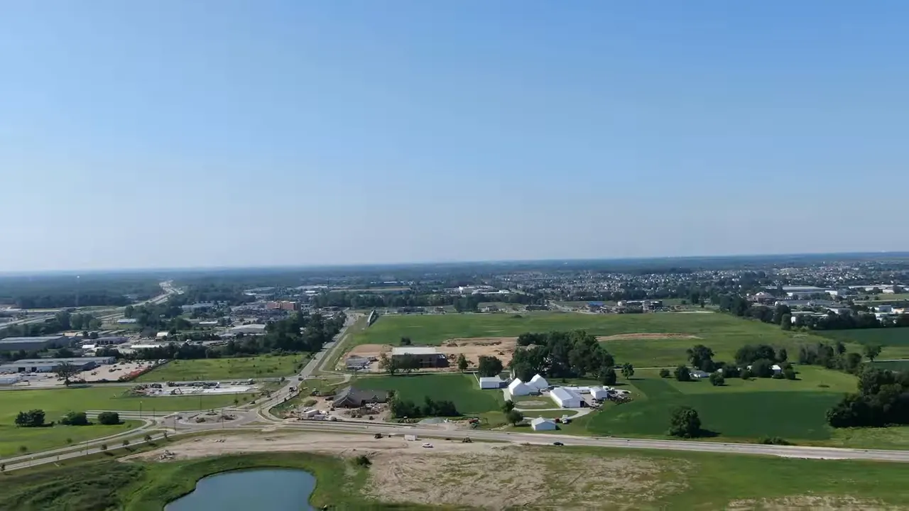 Drone view of Westfield Indiana showing open fields, roads, and development near the city