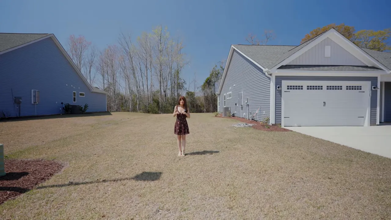 New construction home exterior in Loris SC with spacious between-houses side yard and garage