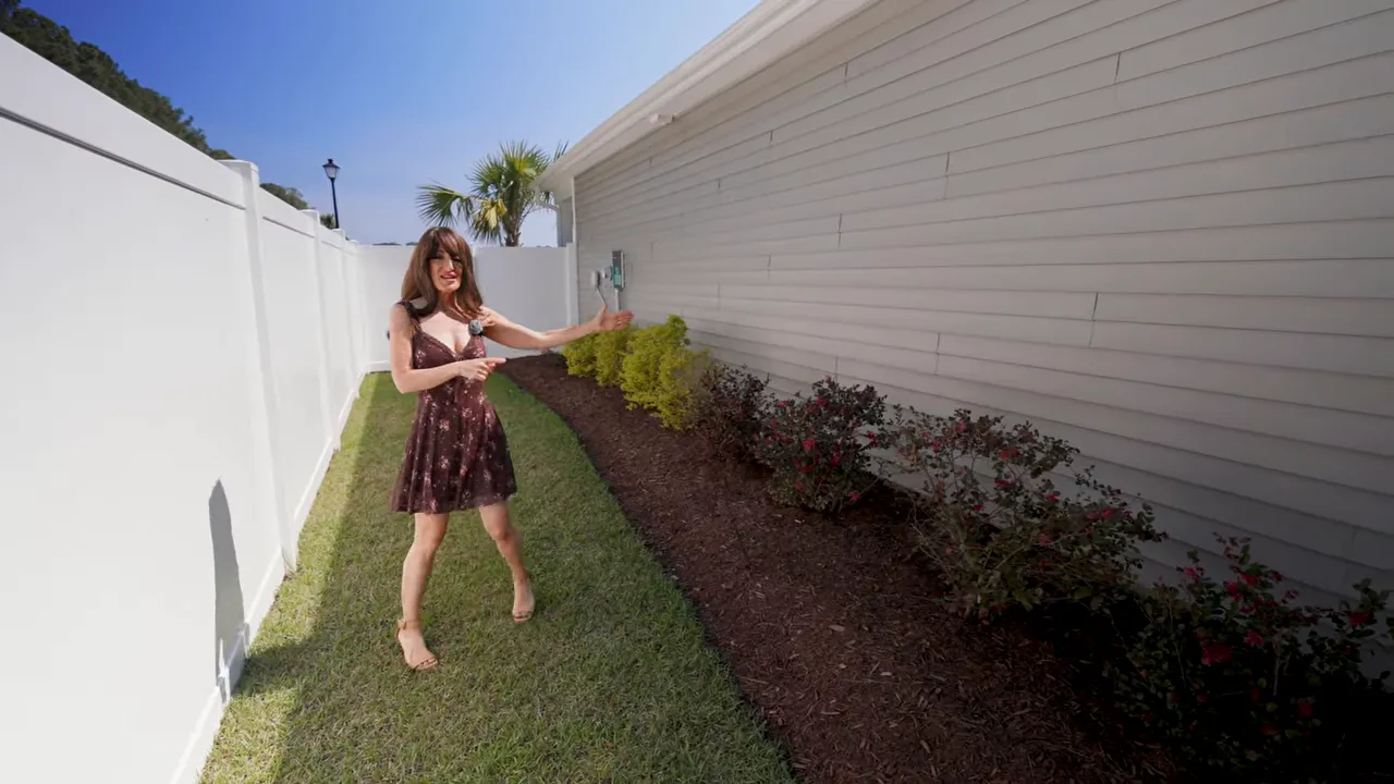 New construction home sideyard with landscaped border and extended privacy fencing