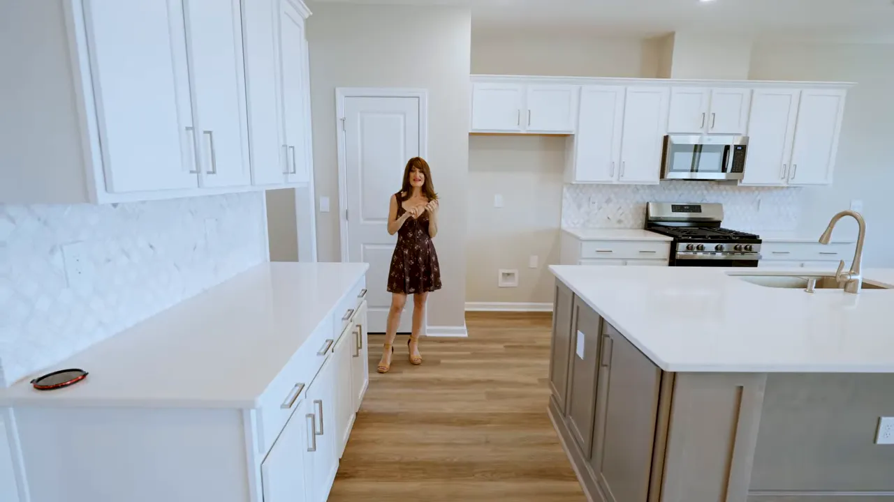New construction kitchen with white cabinets, tile backsplash, and stainless gas range