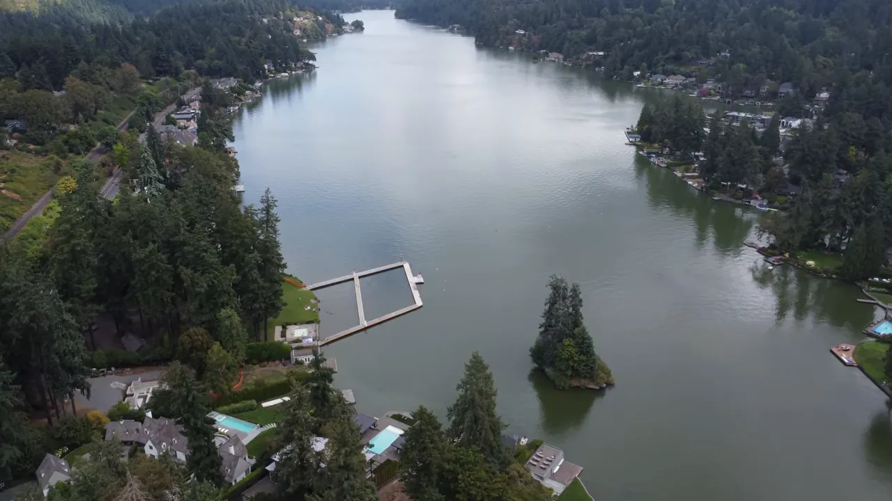 Aerial view looking down Lake Oswego with homes and docks on both shores