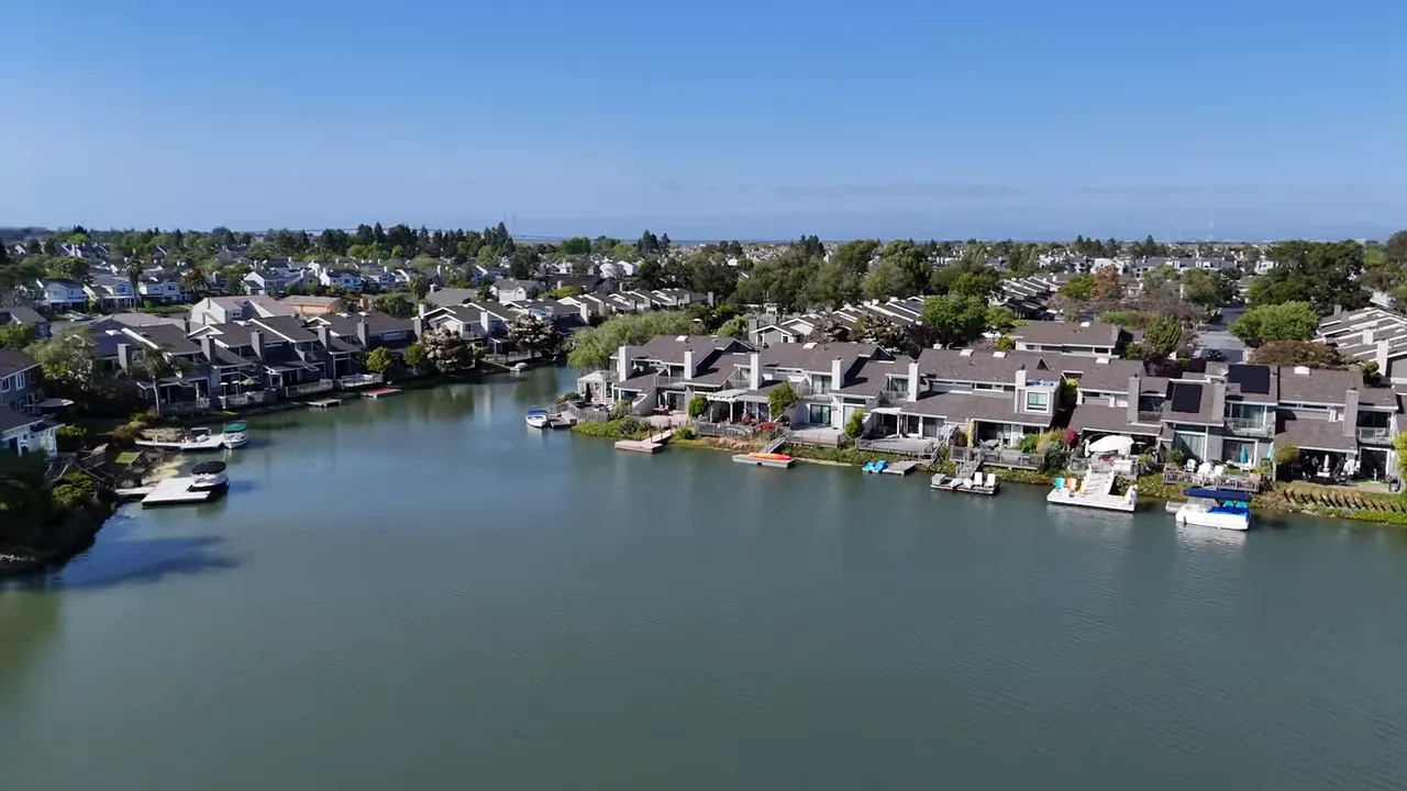 Aerial view of Redwood Shores with homes along a calm lagoon and waterfront