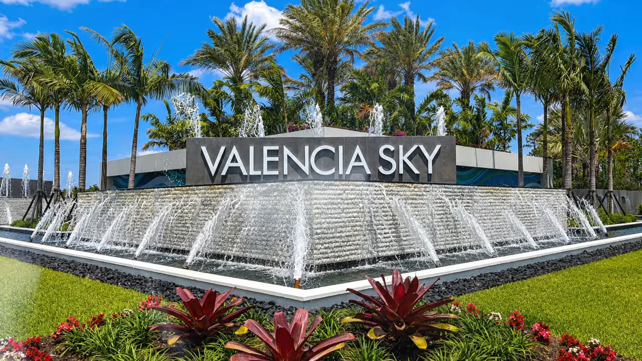 Esplanade community entrance with palm trees and a cascading water feature
