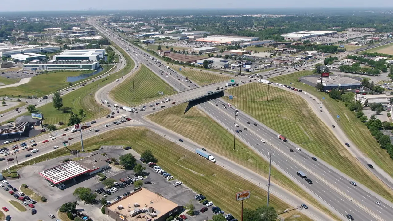 Aerial view of a highway interchange with text reading under 30 minutes
