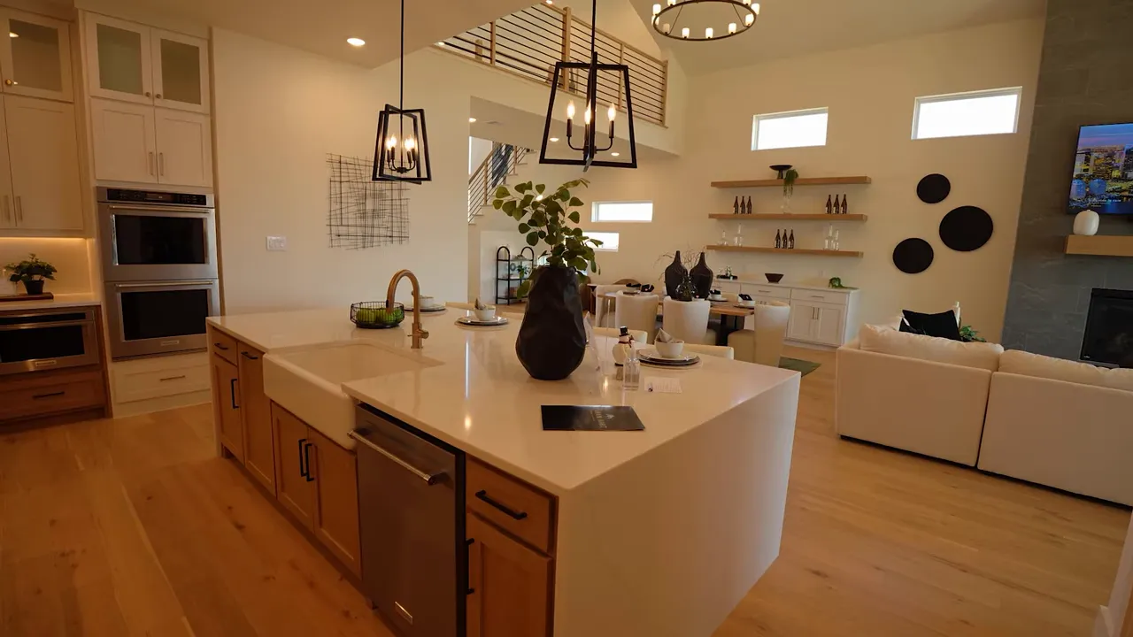 large kitchen island with open living area and high ceilings