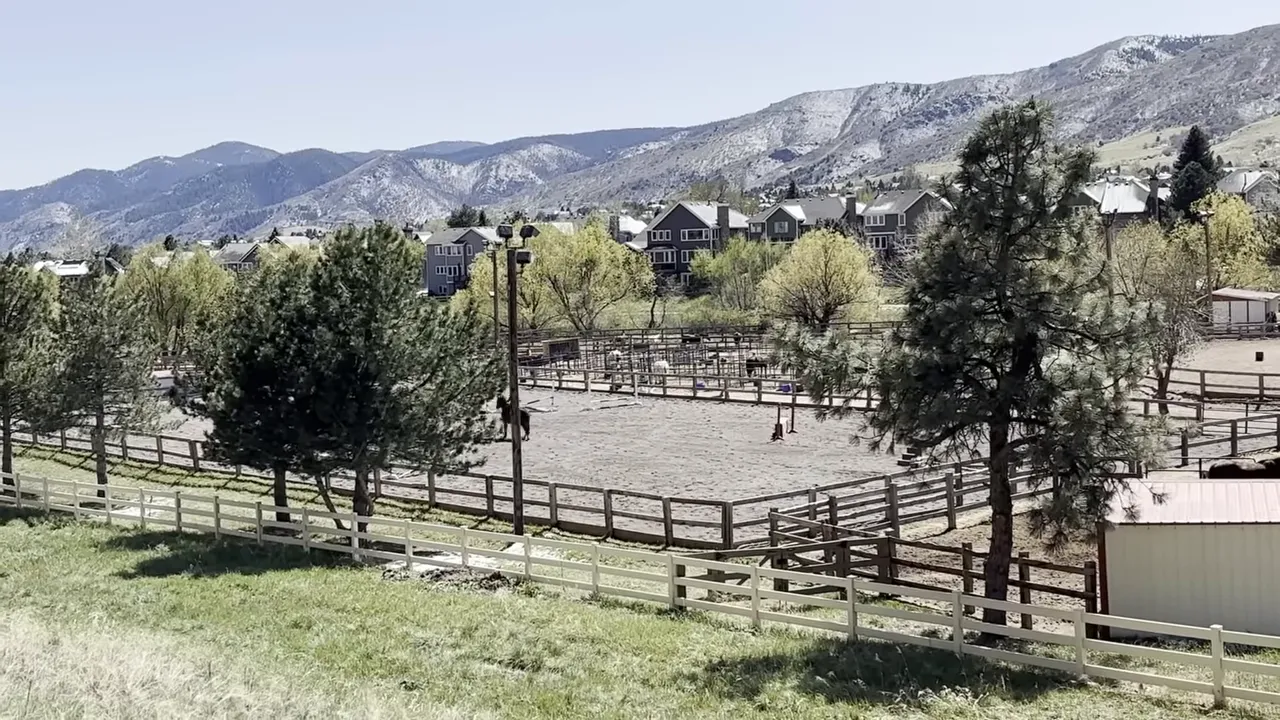 Ken Caryl Valley neighborhood view with fenced pastures and mountain backdrop
