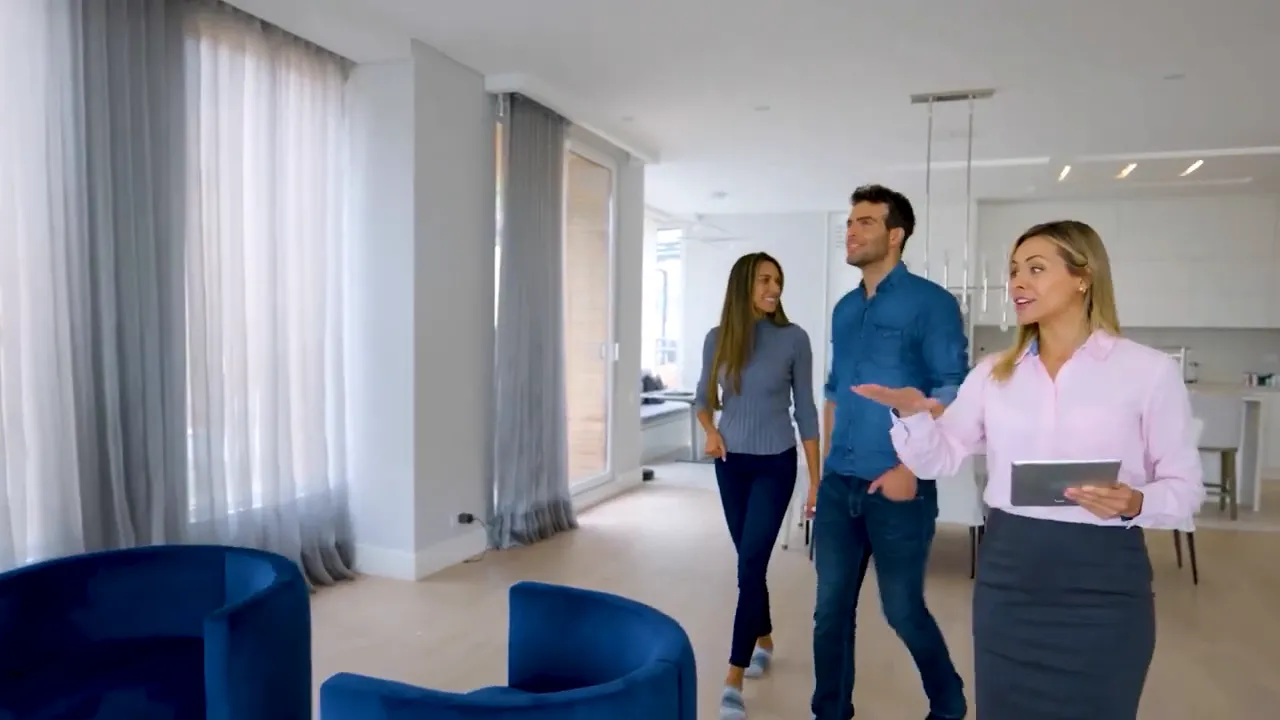 Home buyers conducting a guided walkthrough of a new construction interior before closing