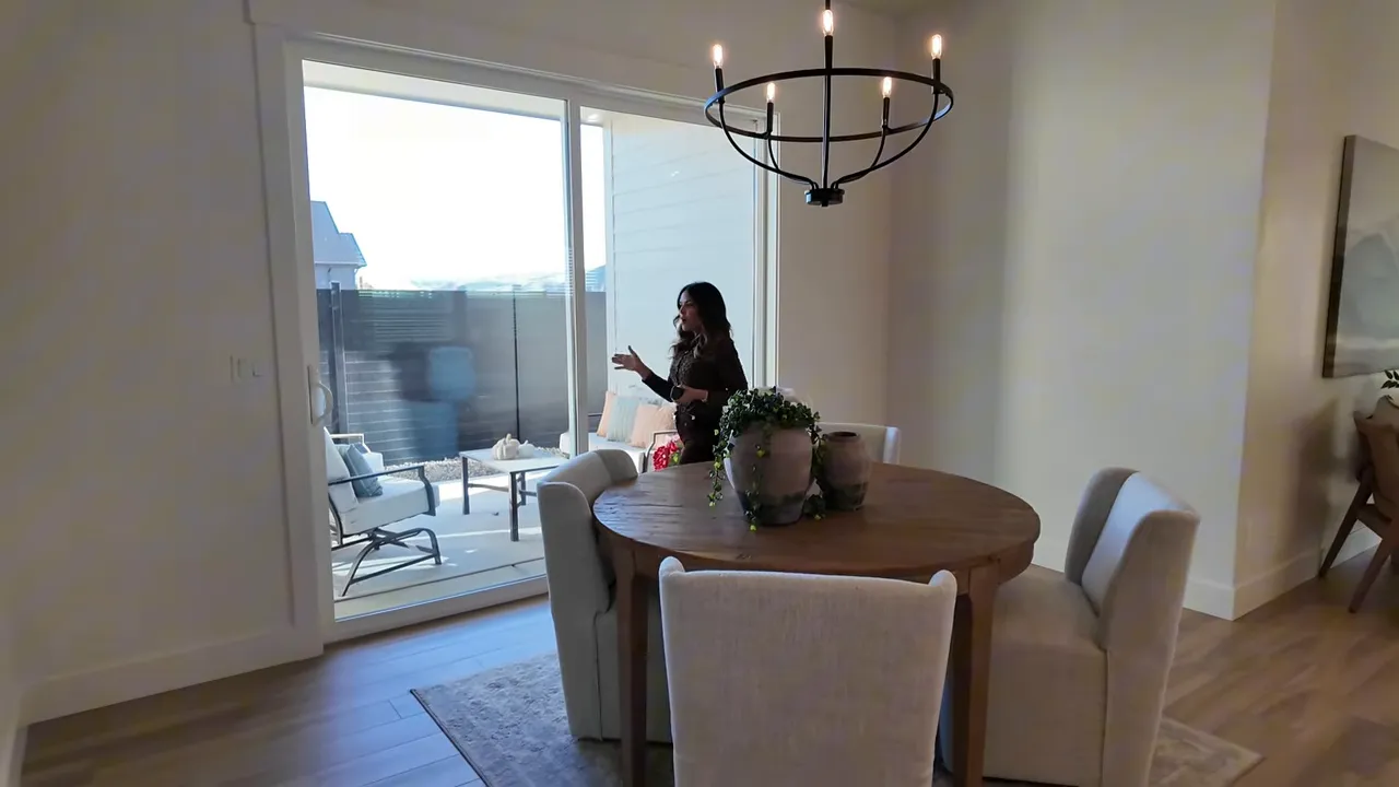 Dining area looking through large sliding doors to a covered patio in Valnova subdivision home