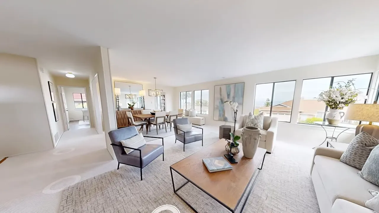 Staged open living and dining room with large windows showing neighborhood and bay views