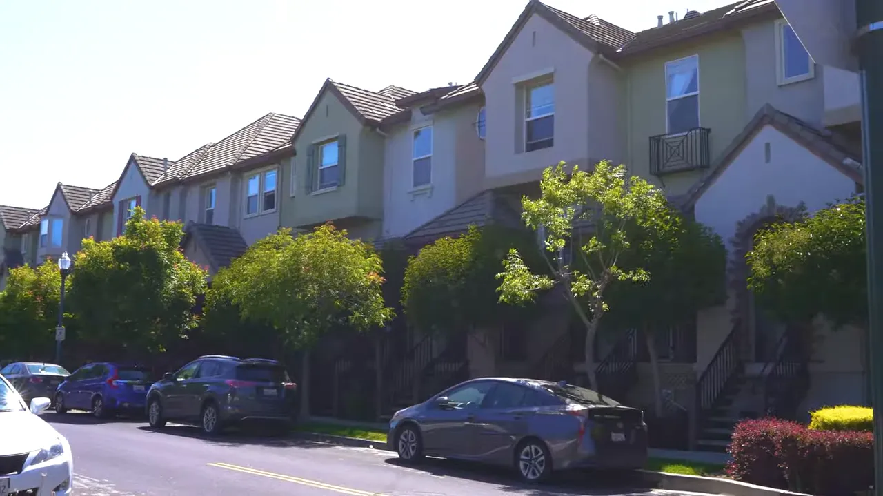 Row of suburban homes with parked cars in San Mateo County