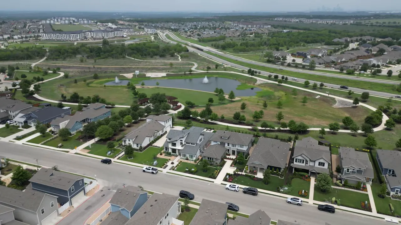 Aerial view of a large suburban neighborhood with roads and green space