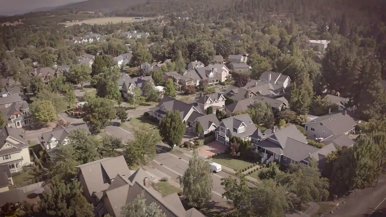 Aerial view of suburban homes surrounded by trees in Southern Oregon