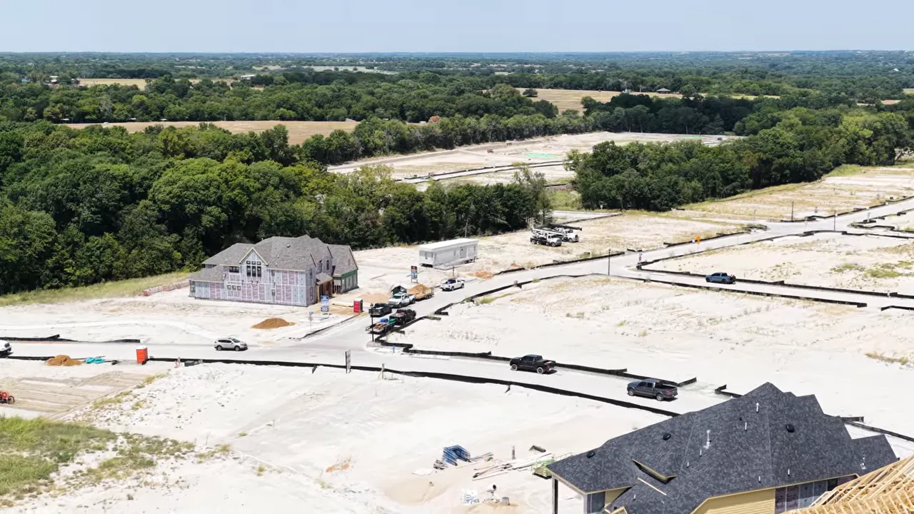 Aerial view of Ridgeline construction beside a dense tree line