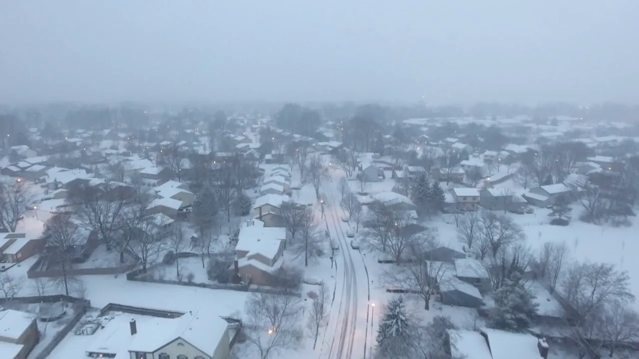 Snow covered neighborhood seen from above during winter weather