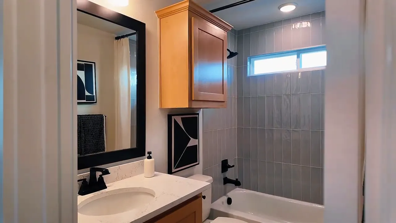 Upstairs bathroom with double vanity and tiled tub surround in a Forney TX new construction home