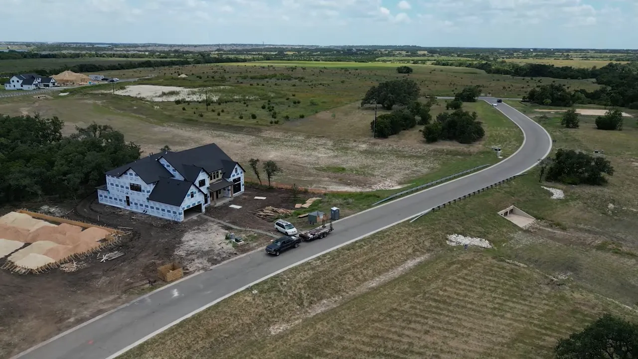 Aerial view of large homesites and developing streets in the Leander Estates area