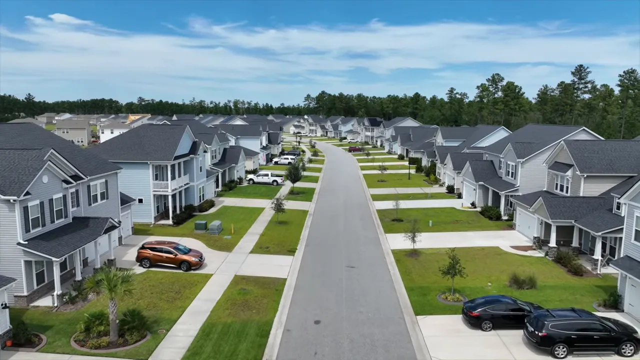 centered aerial view down a residential street in Summerville showing houses and yards