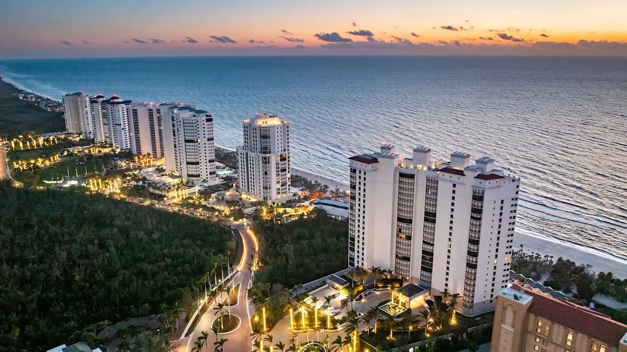 Pelican Bay beachfront high-rise resort buildings at dusk