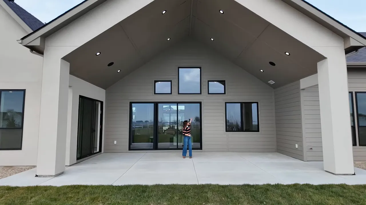 Open covered patio with large glass doors and recessed lights at a new construction home in Middleton Idaho
