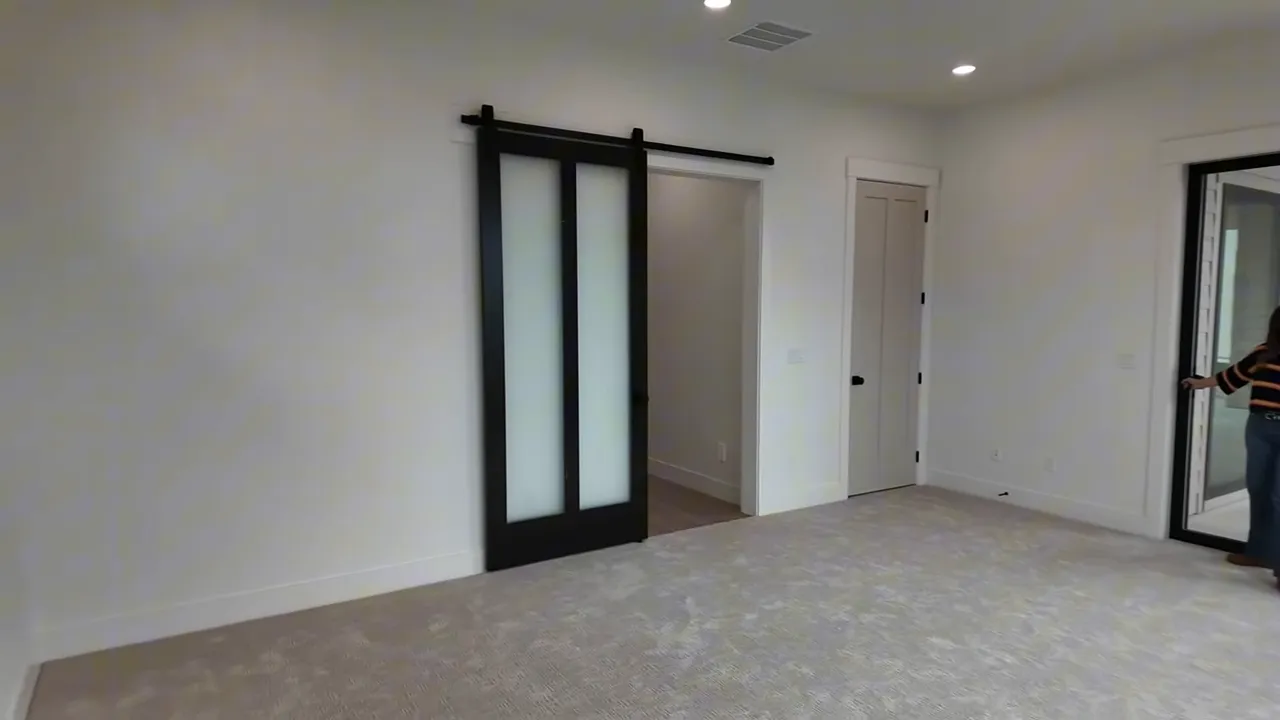 Frosted glass-style interior door and hallway access in new construction home