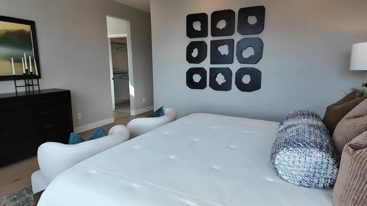 Open loft flex room with neutral decor and seating in Painted Prairie Residence 3 model home