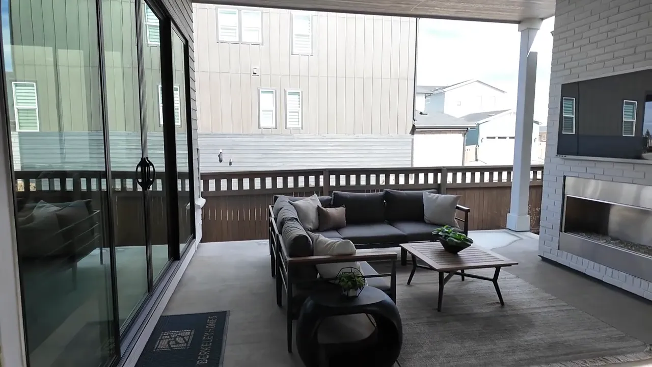 Covered patio with fireplace at Painted Prairie Residence 3 model home