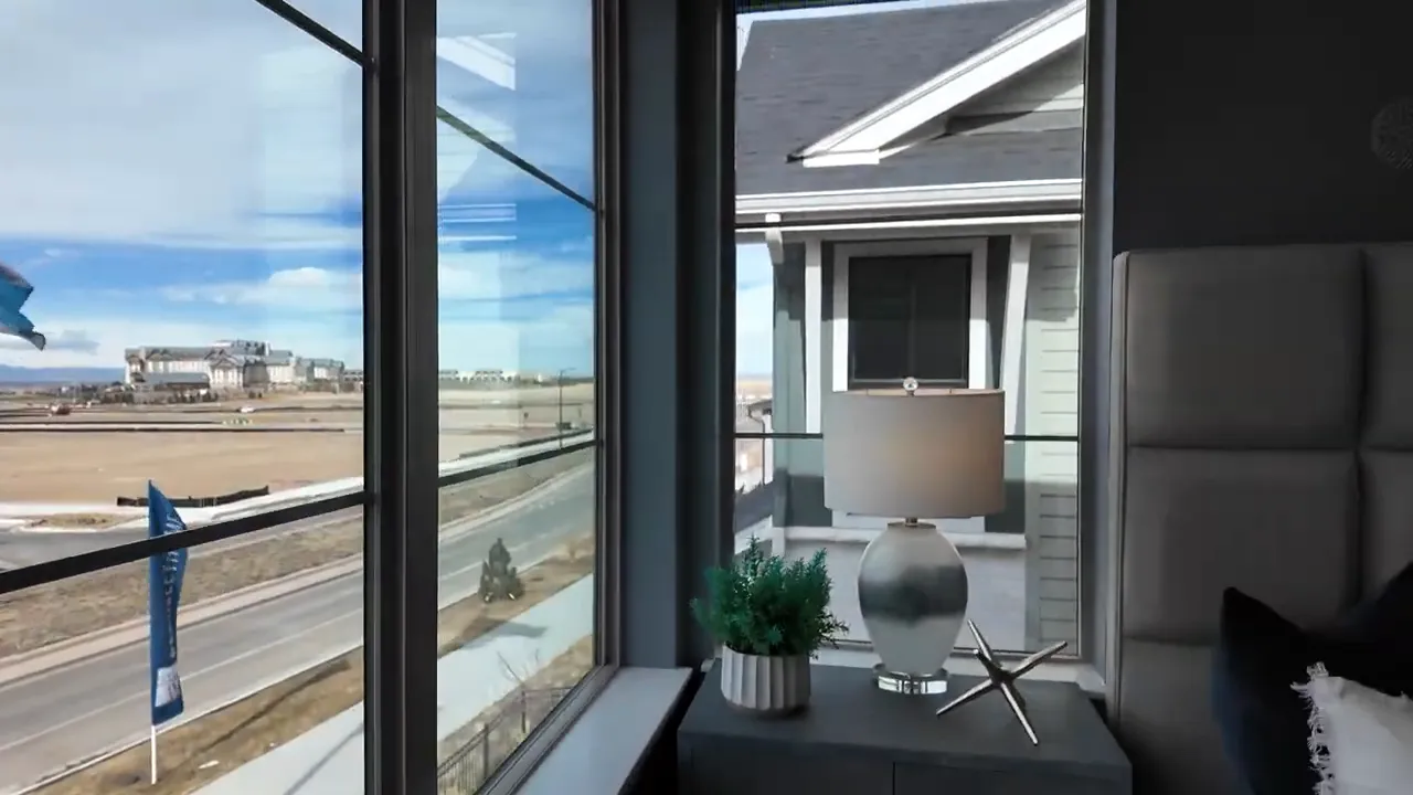 Patio-style seating area by large windows in Painted Prairie Residence 2 with view of surrounding roads and neighborhood