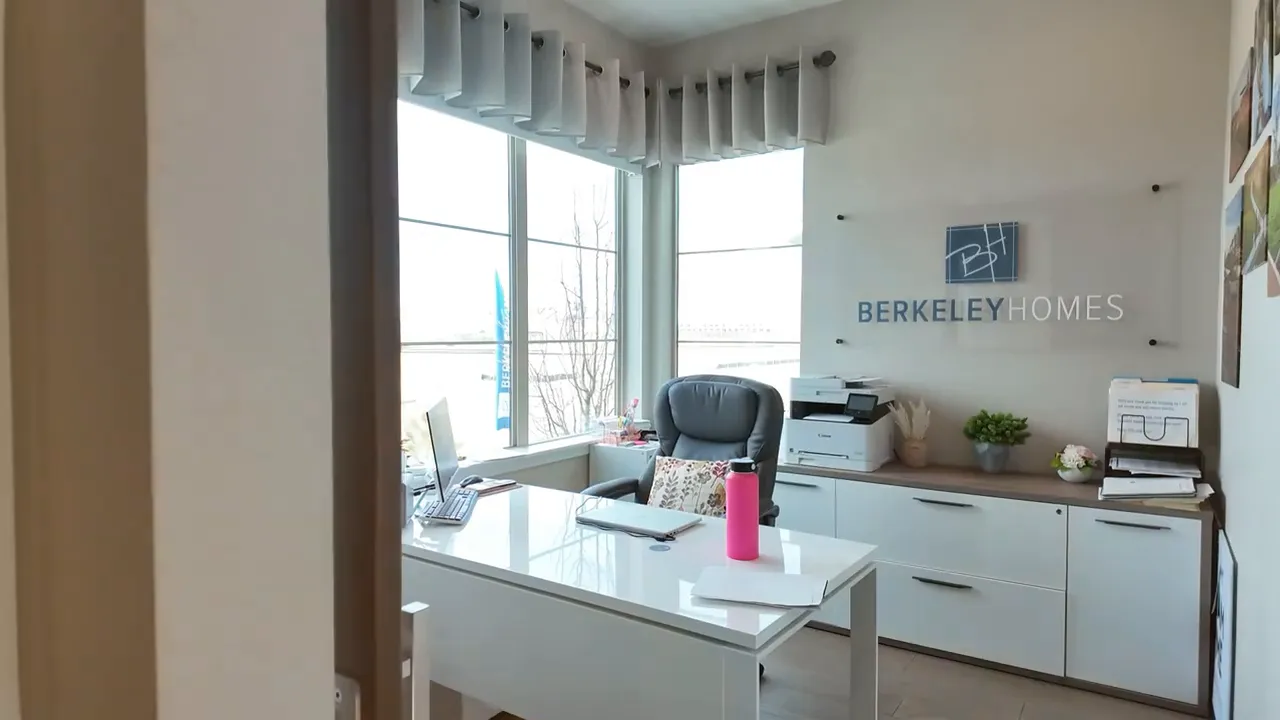 Bright front office room in Painted Prairie Residence 2 model home with desk setup and Berkeley Homes branding